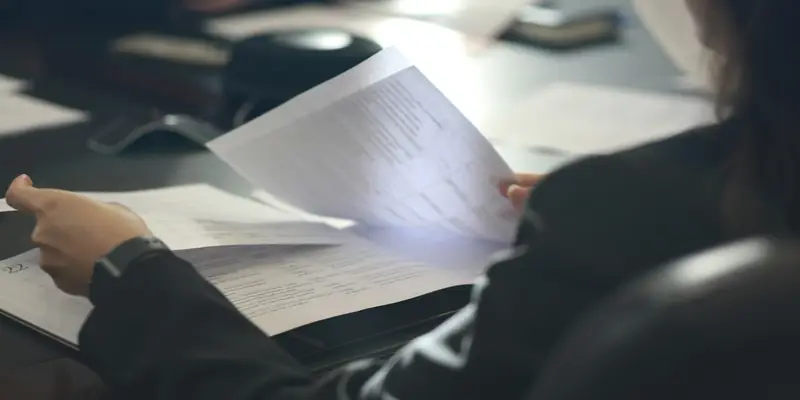 Woman reviewing business documents at a desk