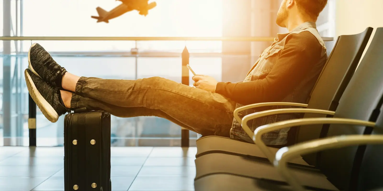 Traveller waiting at an airport gate, Saudi Arabia