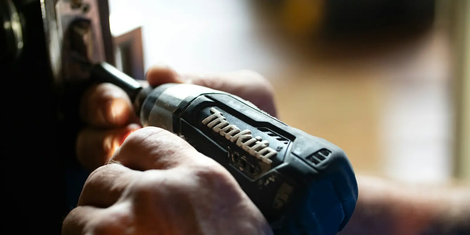 Tradesperson using a power tool for a home repair: Website Design