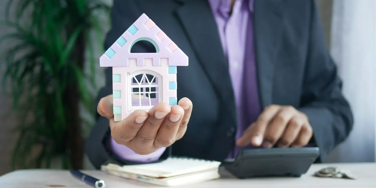 Real estate agent holding a model house: AI Calling Agents