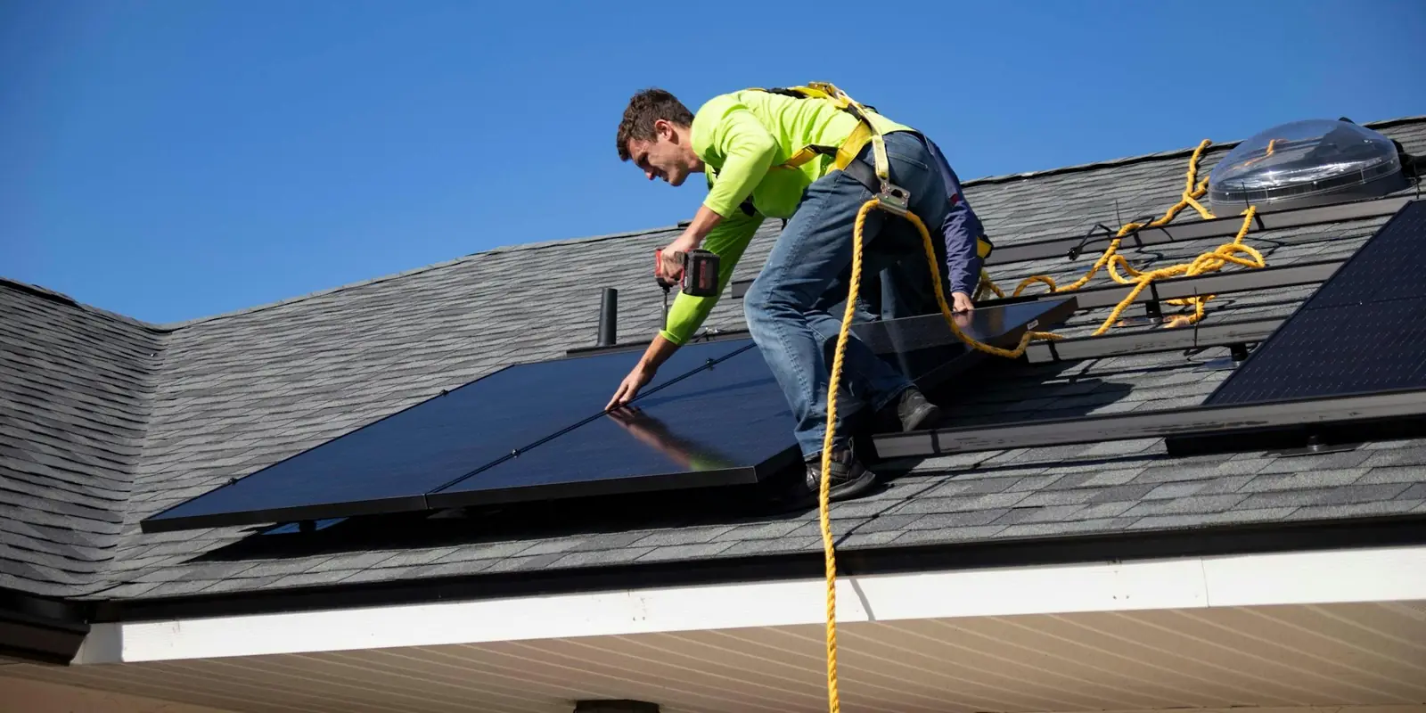 Installer fitting solar panels on a roof