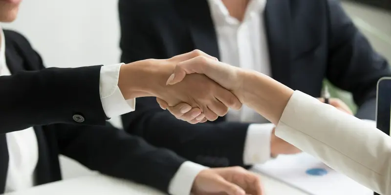Business handshake closing a new deal