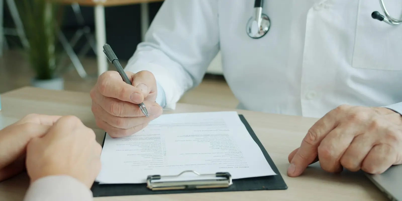 Doctor completing a patient chart for billing (Medical Billing)
