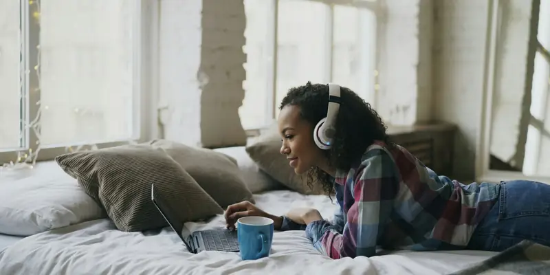 Woman watching videos on a laptop at home